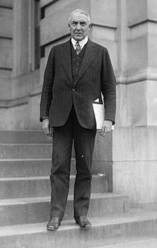 President Warren G. Harding wears a black suit. 