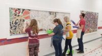 Louise Chell and others working on a mosaic.