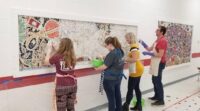 Louise Chell and others working on a mosaic. 