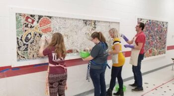 Louise Chell and others working on a mosaic.