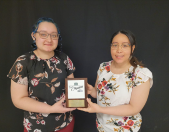 Breanna Malone and her mother, Ana Malone, hold an award for their business.