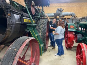 Marion Technical College Professor Jeremy Fryman explains the working of the steam-powered engine to engineering student Michelle Bannister.