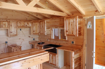 The inside of the cabins is all light colored wood except for a black sink.