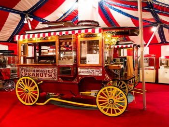 An antique popcorn cart is housed in the museum under a striped circus tent.