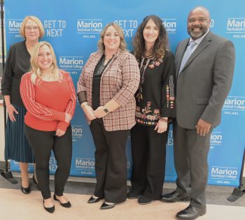 Four women and one man smile after being inducted into the Marion Technical College Alumni Hall of Fame.