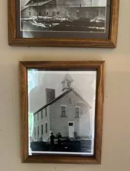 A black-and-white photo of a 2-story stone building.