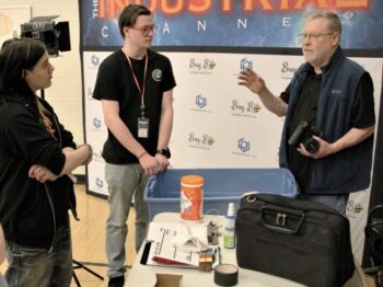 Terry speaks with two student employees.