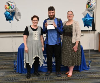 A graduate holds his diploma.