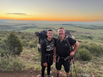 A father and son smile