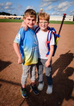 Two boys pose on the field during an Unstoppable game.