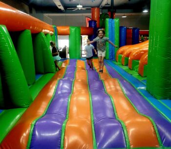 Kids bounce in a large inflatable at the MaxAiir inflatapark.