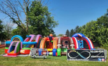 A grassy lawn covered with inflatables.