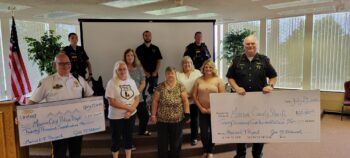 The K9 Project presenting checks for more than $20,000 to the K9 units of the local police and sheriff's departments. 
