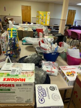 Diapers, wipes, and toys are among the items given at the community baby shower. 