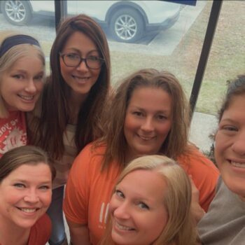 A group of women who make up MAPP's workforce smile. 